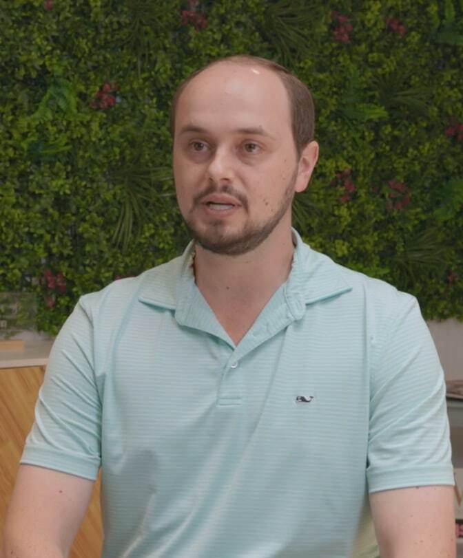 Matt smiles for a testimonial photo at a dental practice in Pompano Beach.