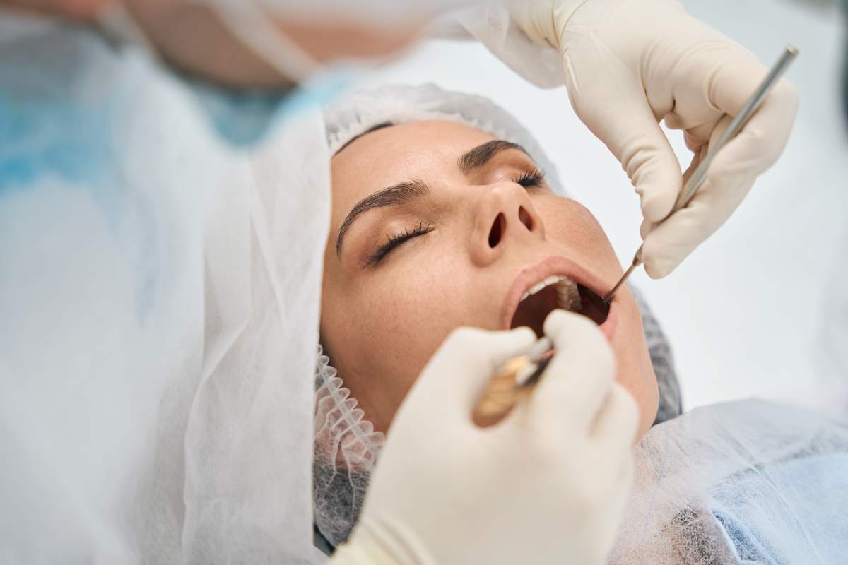 Dentist examining patient's teeth during preventive oral examination in Pompano Beach.